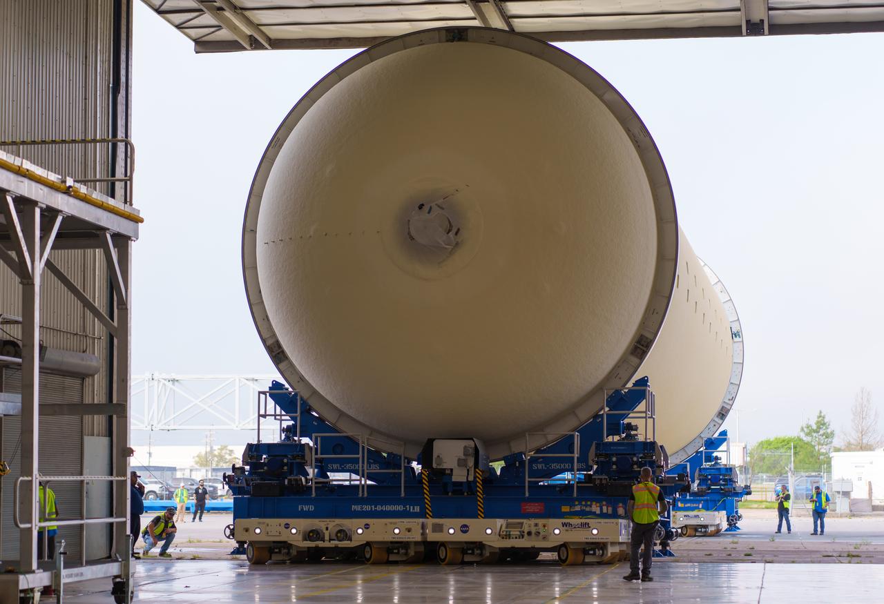 Teams at NASA’s Michoud Assembly Facility in New Orleans move a liquid hydrogen tank for the agency’s SLS (Space Launch System) rocket into the factory’s final assembly area on April 22. Having recently completed application of the thermal protection system, teams will now continue outfitting the 130-foot-tall tank with critical systems to ready it for its designated Artemis III mission. The propellant tank is one of five major elements that make up the 212-foot-tall rocket stage. The core stage, along with its four RS-25 engines, produce more than two million pounds of thrust to help launch NASA’s Orion spacecraft, astronauts, and supplies beyond Earth’s orbit and to the lunar surface for Artemis.